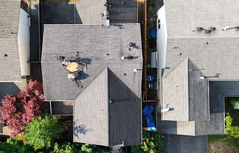 Aerial forensic inspection of a damaged roof section, documenting structural plywood exposure for a GAF Certified insurance restoration claim.