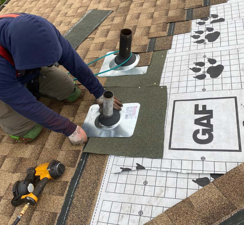 roofer performing roof repair on a gaf roof